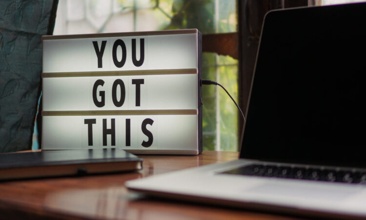 You Got This Sign On Desk With Laptop Computer Sitting Next To It.